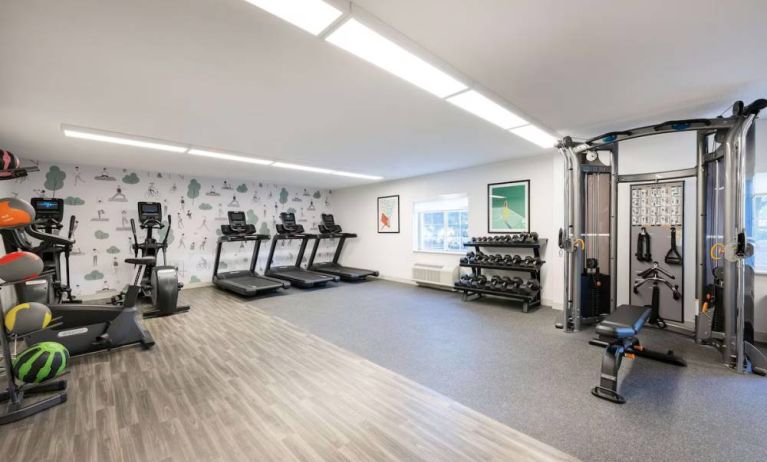 Sonesta Simply Suites Jersey City’s fitness center is equipped with free weights, a variety of exercise machines, gym balls, and art on the walls.