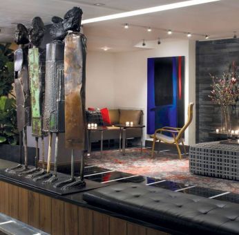 The hotel’s lobby is furnished with stylised sculptures, as well as comfortable seating close to a fireplace.