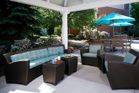 The hotel’s patio has shaded tables and chairs, plus armchair and sofa seating under cover and next to coffee tables.