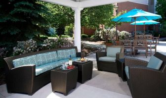 The hotel’s patio has shaded tables and chairs, plus armchair and sofa seating under cover and next to coffee tables.