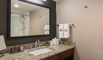 Sonesta Nashville Airport guest bathroom, with shower, sink, and mirror.