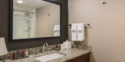 Sonesta Nashville Airport guest bathroom, with shower, sink, and mirror.