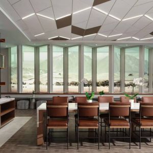 Hotel meeting room, including long table, high ceiling, large windows, and a wall-mounted television.