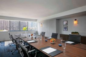 Royal Sonesta Chicago Downtown meeting room, including long table and swivel chairs, with views of the urban landscape.