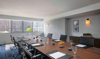 Royal Sonesta Chicago Downtown meeting room, including long table and swivel chairs, with views of the urban landscape.