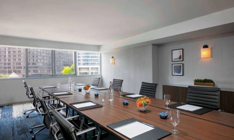 Royal Sonesta Chicago Downtown meeting room, including long table and swivel chairs, with views of the urban landscape.