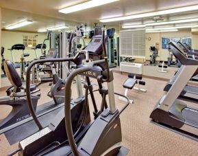 Sonesta Simply Suites Phoenix Tempe’s fitness center has a mirrored wall and a range of exercise equipment.