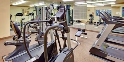 Sonesta Simply Suites Phoenix Tempe’s fitness center has a mirrored wall and a range of exercise equipment.