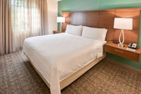 Double bed guest room in Sonesta ES Suites Fort Lauderdale Plantation, including bedside lamps and a window.