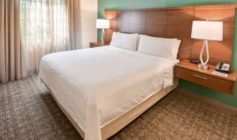 Double bed guest room in Sonesta ES Suites Fort Lauderdale Plantation, including bedside lamps and a window.