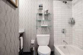 Guest bathroom in The Allegro Royal Sonesta Hotel Chicago Loop, featuring bath and shower, and a lavatory.