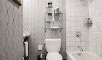 Guest bathroom in The Allegro Royal Sonesta Hotel Chicago Loop, featuring bath and shower, and a lavatory.