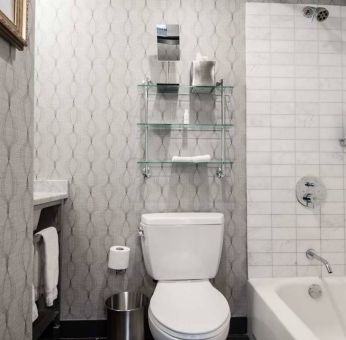 Guest bathroom in The Allegro Royal Sonesta Hotel Chicago Loop, featuring bath and shower, and a lavatory.