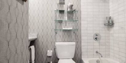 Guest bathroom in The Allegro Royal Sonesta Hotel Chicago Loop, featuring bath and shower, and a lavatory.