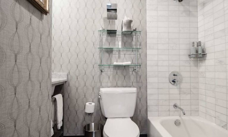 Guest bathroom in The Allegro Royal Sonesta Hotel Chicago Loop, featuring bath and shower, and a lavatory.