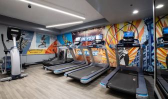 The fitness center in The Allegro Royal Sonesta Hotel Chicago Loop has assorted types of exercise machine and motivational artwork on the wall.