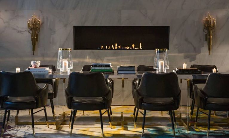 The Allegro Royal Sonesta Hotel Chicago Loop’s lobby lounge includes a table, comfortable seating, and a fireplace.