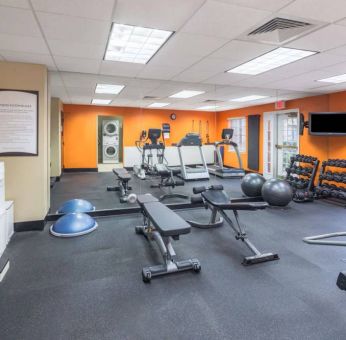 Sonesta ES Suites Atlanta - Perimeter Center’s fitness center has both free weights and a range of exercise machines, plus benches and a wall-mounted TV.