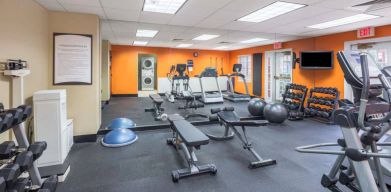 Sonesta ES Suites Atlanta - Perimeter Center’s fitness center has both free weights and a range of exercise machines, plus benches and a wall-mounted TV.