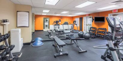 Sonesta ES Suites Atlanta - Perimeter Center’s fitness center has both free weights and a range of exercise machines, plus benches and a wall-mounted TV.