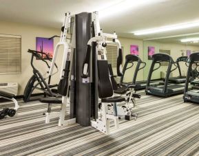 Sonesta Simply Suites Detroit Troy’s fitness center includes free weights, a mirrored wall, and various types of exercise machine.