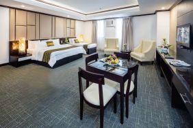 Spacious king room with dining area at Apo View Hotel.