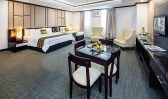 Spacious king room with dining area at Apo View Hotel.