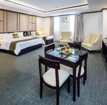 Spacious king room with dining area at Apo View Hotel.