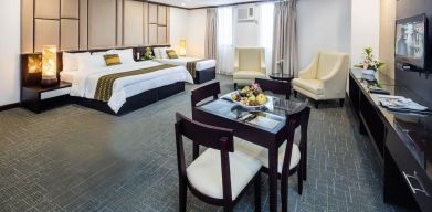 Spacious king room with dining area at Apo View Hotel.