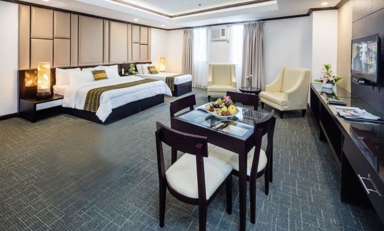 Spacious king room with dining area at Apo View Hotel.