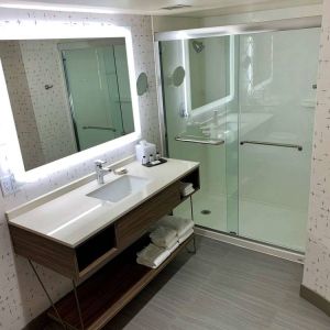 Guest bathroom in Sonesta Columbus Downtown, with shower, sink, and mirror.