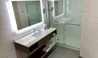 Guest bathroom in Sonesta Columbus Downtown, with shower, sink, and mirror.