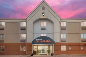 The hotel’s exterior includes potted plants by the front door, above which is the name Sonesta Simply Suites.