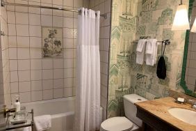 Guest bathroom in Royal Sonesta Portland Downtown, including sink, mirror, lavatory, and bath.