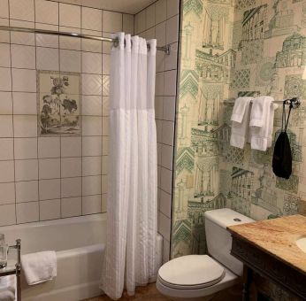 Guest bathroom in Royal Sonesta Portland Downtown, including sink, mirror, lavatory, and bath.