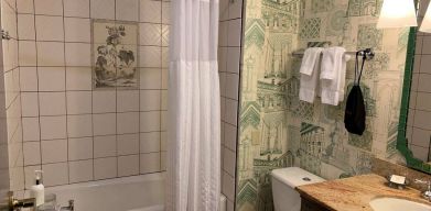 Guest bathroom in Royal Sonesta Portland Downtown, including sink, mirror, lavatory, and bath.