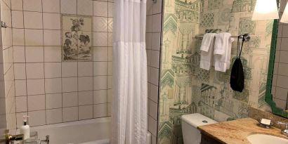 Guest bathroom in Royal Sonesta Portland Downtown, including sink, mirror, lavatory, and bath.