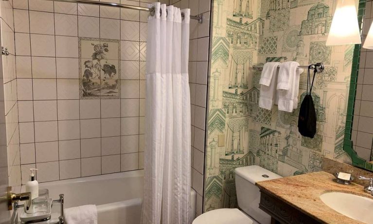 Guest bathroom in Royal Sonesta Portland Downtown, including sink, mirror, lavatory, and bath.