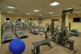 Royal Sonesta Portland Downtown’s fitness center is equipped with free weights, a wall-mounted TV, and assorted exercise machines.