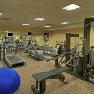 Royal Sonesta Portland Downtown’s fitness center is equipped with free weights, a wall-mounted TV, and assorted exercise machines.