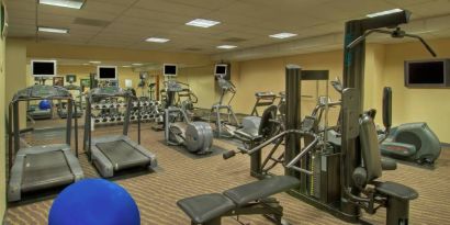 Royal Sonesta Portland Downtown’s fitness center is equipped with free weights, a wall-mounted TV, and assorted exercise machines.