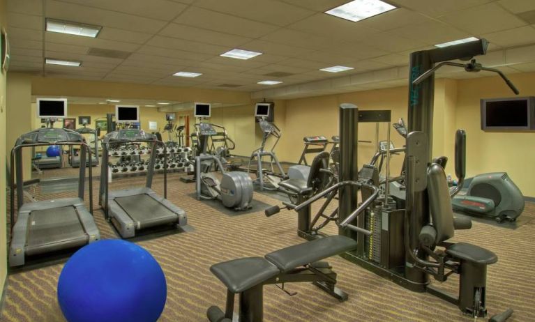 Royal Sonesta Portland Downtown’s fitness center is equipped with free weights, a wall-mounted TV, and assorted exercise machines.