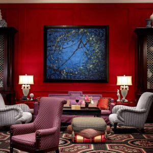 The lobby lounge in Royal Sonesta Portland Downtown is furnished with comfortable armchair and sofa seating, coffee tables, and art on the wall.