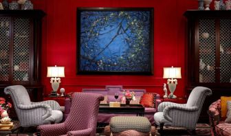 The lobby lounge in Royal Sonesta Portland Downtown is furnished with comfortable armchair and sofa seating, coffee tables, and art on the wall.