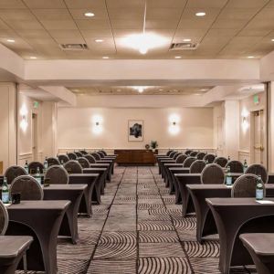 Royal Sonesta Portland Downtown meeting room, with tables arranged in a classroom format and seating for dozens of attendees.