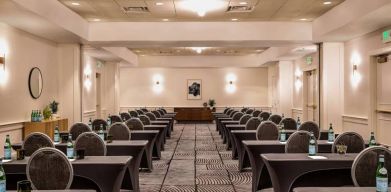 Royal Sonesta Portland Downtown meeting room, with tables arranged in a classroom format and seating for dozens of attendees.