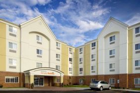 The hotel’s exterior has parking close to the front door, which features potted plants and has the Sonest Simply Suites name above it.