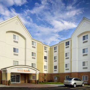 The hotel’s exterior has parking close to the front door, which features potted plants and has the Sonest Simply Suites name above it.