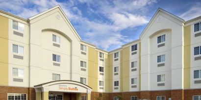 The hotel’s exterior has parking close to the front door, which features potted plants and has the Sonest Simply Suites name above it.