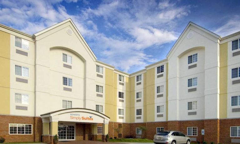 The hotel’s exterior has parking close to the front door, which features potted plants and has the Sonest Simply Suites name above it.